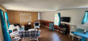 a living room with chairs and a couch and a tv at Millie`s Place in Luray