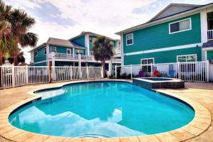 a swimming pool in front of a house at Chic 3 BR Home With Pool and Hot Tub in Port Aransas