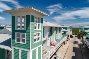 a row of colorful houses on a street at Chic 3 BR Home With Pool and Hot Tub in Port Aransas