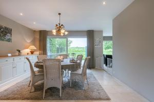 a kitchen and dining room with a table and chairs at Guesthouse in the heart of the flemish ardennes in Zwalm