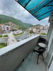 a balcony with two chairs and a table at Apartmani MV in Užice
