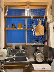 a kitchen with a sink and a window at 経堂の小さなお部屋cottu in Tokyo