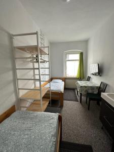 a bedroom with a bunk bed and a desk at Bigus in Berlin