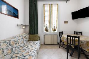 a living room with a couch and a table at Numero 10 in Pietra Ligure