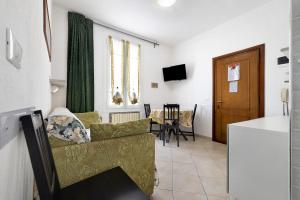 a living room with a couch and a table at Numero 10 in Pietra Ligure