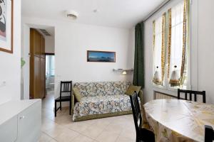 a living room with a couch and a table at Numero 10 in Pietra Ligure