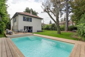 uma piscina no quintal de uma casa em Familial villa with pool - Tassin-la-Demi-Lune - Welkeys em Tassin-la-Demi-Lune
