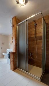 a bathroom with a shower with a sliding glass door at Maison Glarey Courmayeur CIR VdA 0023 in Courmayeur