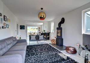 a living room with a couch and a fireplace at Pen Y Mor in Mawgan Porth