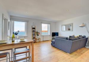 a living room with a couch and a table at The Lookout - Sennen in Sennen