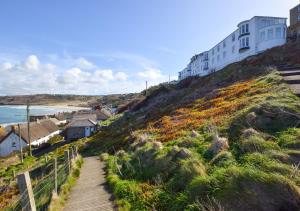 a path up a hill with a building on it at The Lookout - Sennen in Sennen