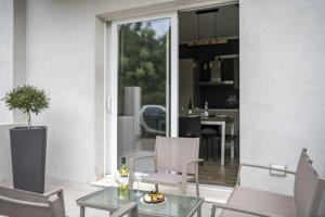 een woonkamer met een glazen tafel en stoelen bij KT House - Tortolì in Tortolì