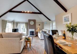 a living room with a dining table and a living room at Otterbridge in Saint Breward
