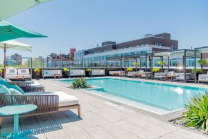 a swimming pool with chairs and tables on a building at The William Vale in Brooklyn