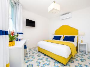 Blue Waves في بوسيتانو: غرفة نوم بسرير كبير مع اللوح الأمامي الأصفر