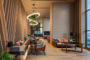 a lobby of a hotel with couches and tables at Sukhumvit 36,Japanese style condominium,central area,high-rise view,BTS Thonglo in Bangkok