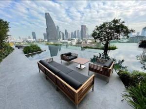 a rooftop patio with benches and a view of a city at Sukhumvit 36,Japanese style condominium,central area,high-rise view,BTS Thonglo in Bangkok