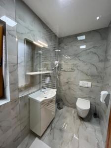 y baño con lavabo blanco y aseo. en Rustic Inn River 2, en Lagos de Plitvice