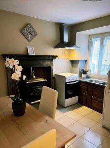 a kitchen with a table and a stove top oven at La Casetta in Montefegatesi