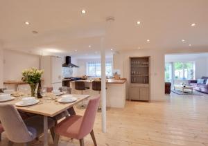 a dining room and kitchen with a table and chairs at St Mellyn in Mevagissey