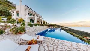 a villa with a swimming pool and a house at Villa Zeitouni in Nisakion
