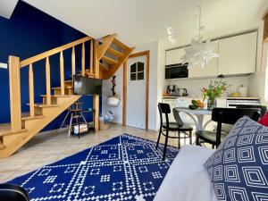 a living room with a blue and white rug at Klara w Ogrodzie in Łeba