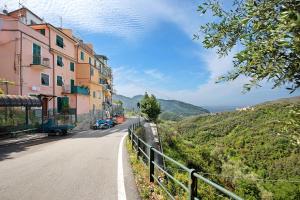 a road with a building on the side of a hill at Casa Luci in Levanto