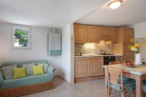 a kitchen with a couch and a table in a room at Casa Luci in Levanto +26 photos