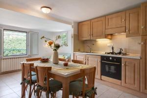 a kitchen with a wooden table with chairs and a table and a table at Casa Luci in Levanto