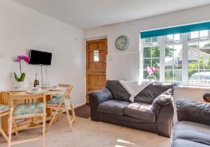 a living room with a couch and a table at Coverack Cottage in Saint Keverne
