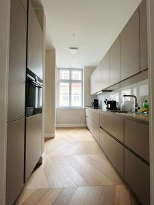 a kitchen with white cabinets and a wooden floor at Luxury Home / 3-Raum-Suite an der Frauenkirche / 6 in Dresden +12 photos