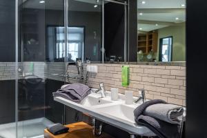 a bathroom with a sink and a mirror at The Green Rostock Apartment Hotel in Rostock