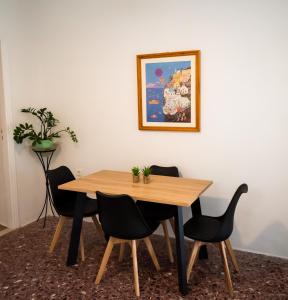 a dining room table with chairs and a picture on the wall at Morning Star Traditional Houses in Pirgos