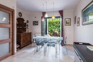 a dining room with a glass table and chairs at Siliqua House with Garden by Wonderful Italy in Trecastagni