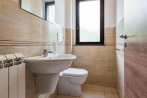 a bathroom with a sink and a toilet and a window at Siliqua House with Garden by Wonderful Italy in Trecastagni +19 photos