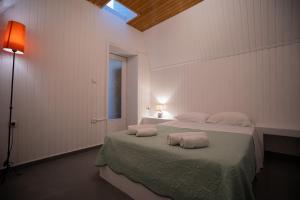 a bedroom with a bed with two pillows on it at Morning Star Traditional Houses in Pyrgos