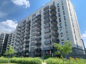 an apartment building with balconies on the side of it at Skanstes Apartment Free Parking in Rīga