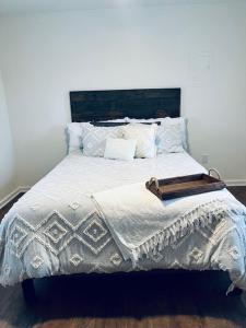 a bedroom with a large bed with a wooden headboard at Farm Charm 