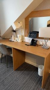 a desk in a room with a phone and a printer at Hotels 24-7 - The Old Victoria Hotel in Newport