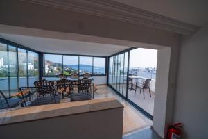 a room with a balcony with a table and chairs at İlya Apart 2 in Bodrum City