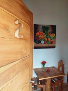 a door to a room with a table and a painting at Villas Montelindo in Constanza