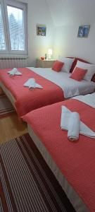 two beds sitting next to each other in a bedroom at Villa Bella in Ilidža