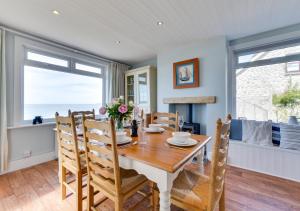 a dining room with a table and chairs at Uplands in Praa Sands