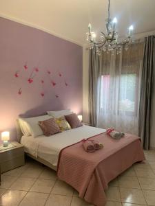 a bedroom with a bed and a chandelier at Butterfly House in Villaputzu