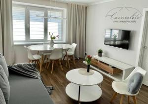 a white living room with a table and chairs at Kintai Carmelite apartment in Kintai