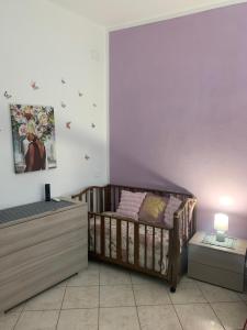 a baby room with a crib and a table at Butterfly House in Villaputzu