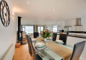 a kitchen and dining room with a table and chairs at Neptune House in Porthleven