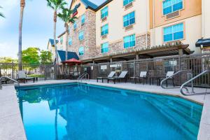 a swimming pool at a hotel with tables and chairs at TownePlace Suites by Marriott Yuma in Yuma