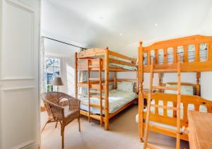 a bedroom with two bunk beds and a table at Cross House in Saint Issey