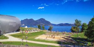 a crowd of people on a field next to a body of water at Al Centro in Verbania